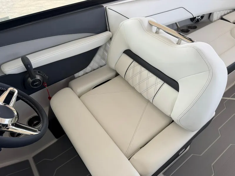 Slide: The Image of 2025 Regal LS4 Surf boat interior with luxurious white seating and modern steering wheel. - 38