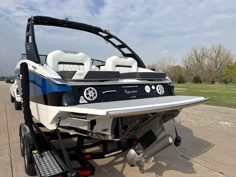 Slide: The Image of 2025 Regal LS4 Surf boat on trailer, rear view with propeller and speakers visible. - 6