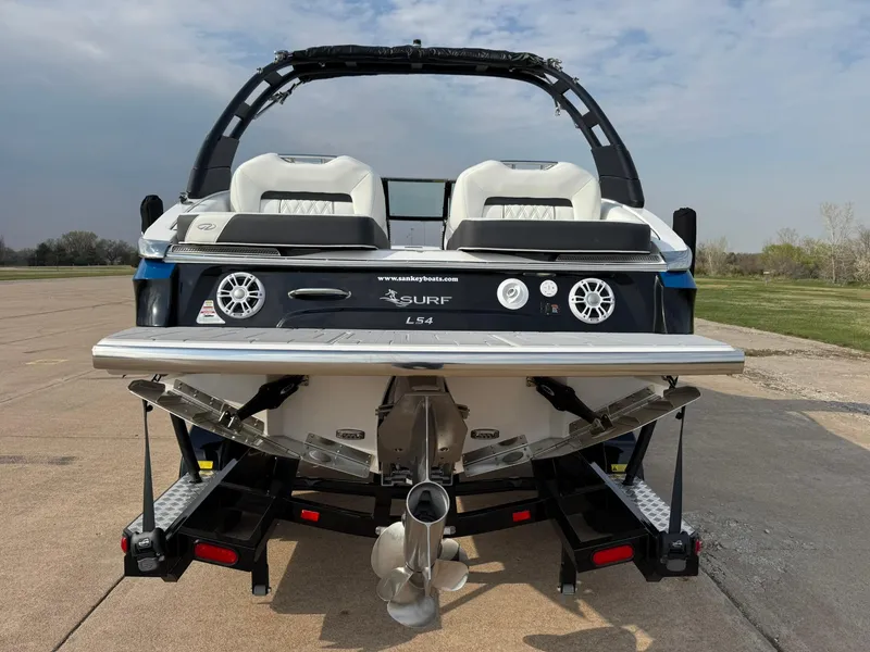 Slide: The Image of 2025 Regal LS4 Surf boat rear view, showcasing dual seats and surf platform. - 7