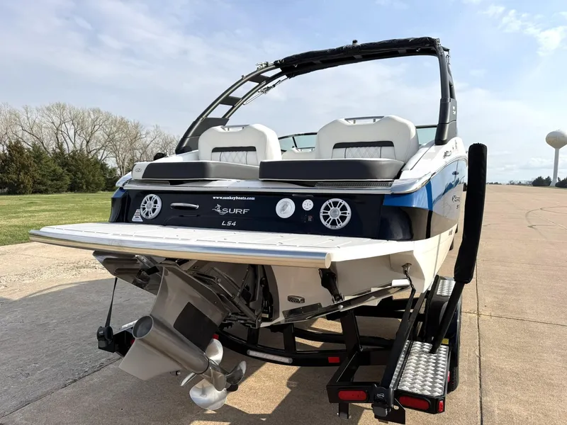Slide: The Image of 2025 Regal LS4 Surf boat, rear view, showcasing sleek design and powerful engine. - 8