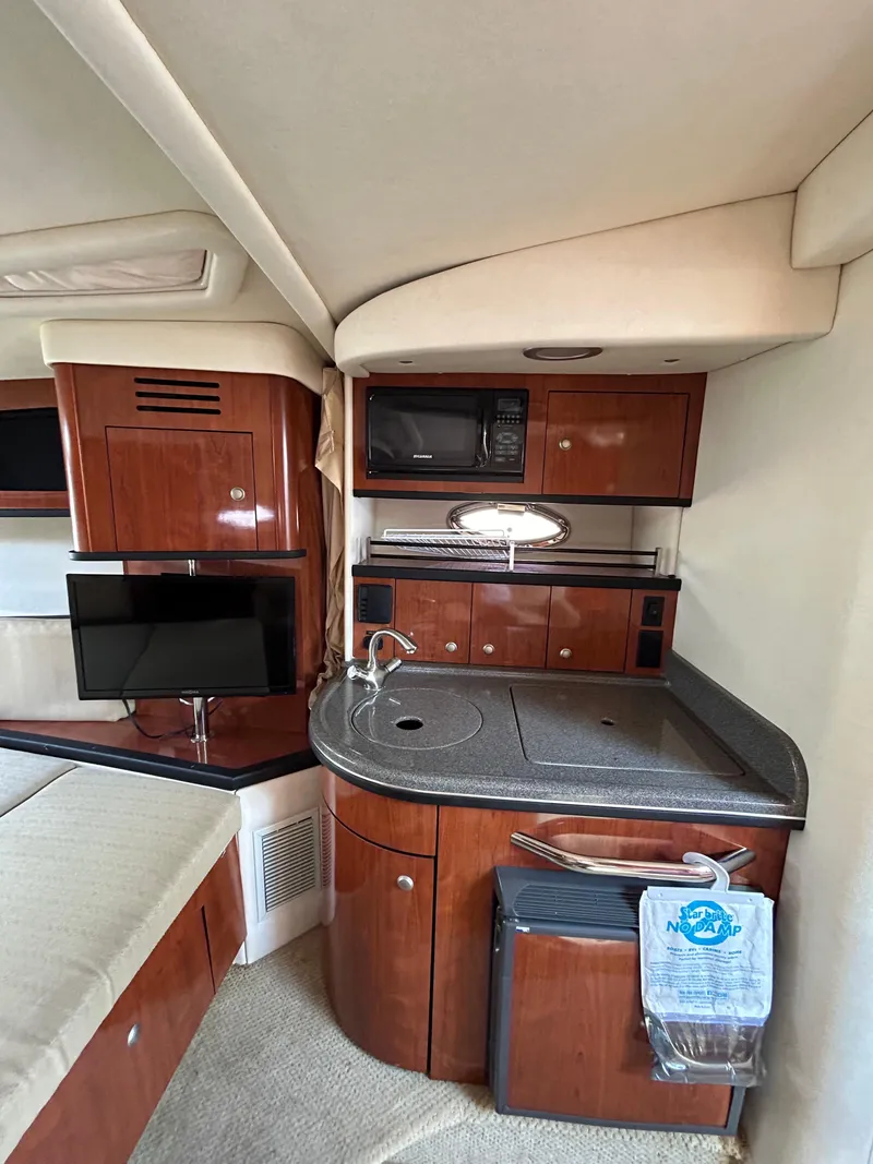 Slide: The Image of 2006 Sea Ray 290 Sundancer interior with kitchenette, TV, and microwave. - 5