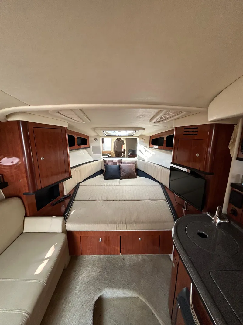 Slide: The Image of Interior of 2006 Sea Ray 290 Sundancer with cozy seating and elegant wood finishes. - 7