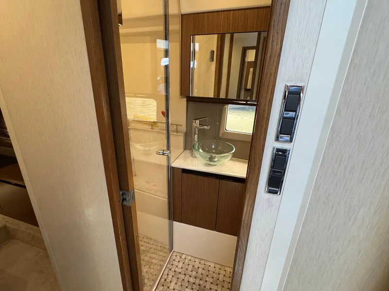 Slide: The Image of 2017 Sea Ray Sundancer 460 bathroom with glass sink and modern fixtures. - 17