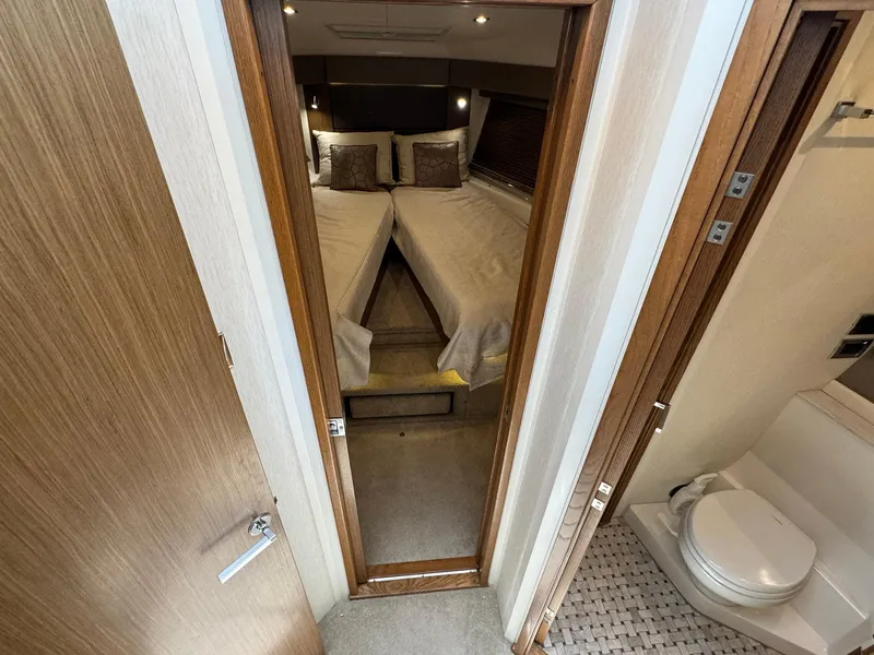 Slide: The Image of 2017 Sea Ray Sundancer 460 interior with cozy bedroom and modern bathroom. - 25