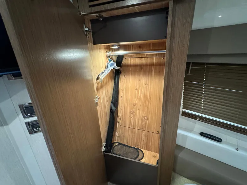 Slide: The Image of Open closet in 2017 Sea Ray Sundancer 460 yacht interior. - 27