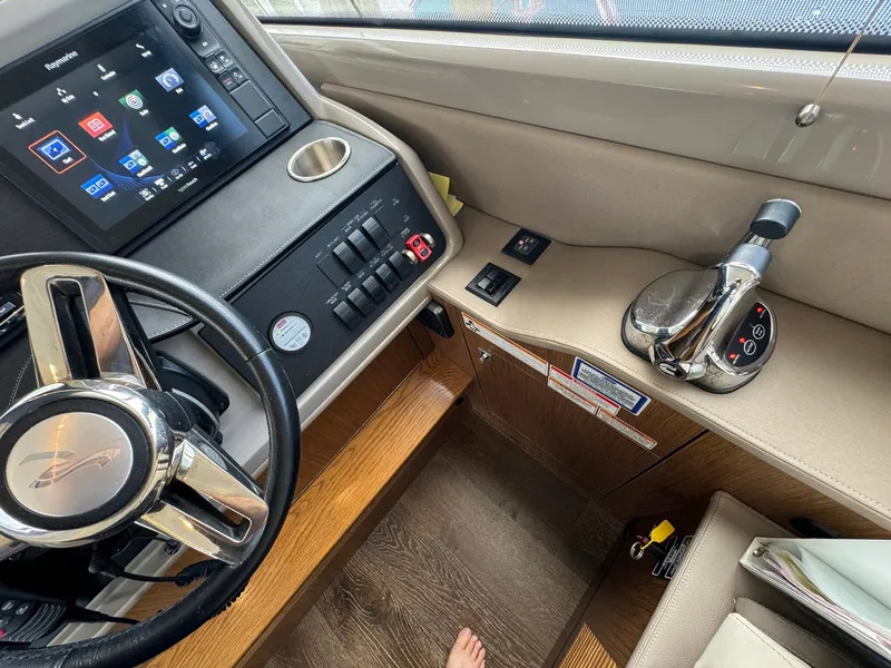 Slide: The Image of Interior helm of 2017 Sea Ray Sundancer 460 yacht with steering wheel and control panel. - 5