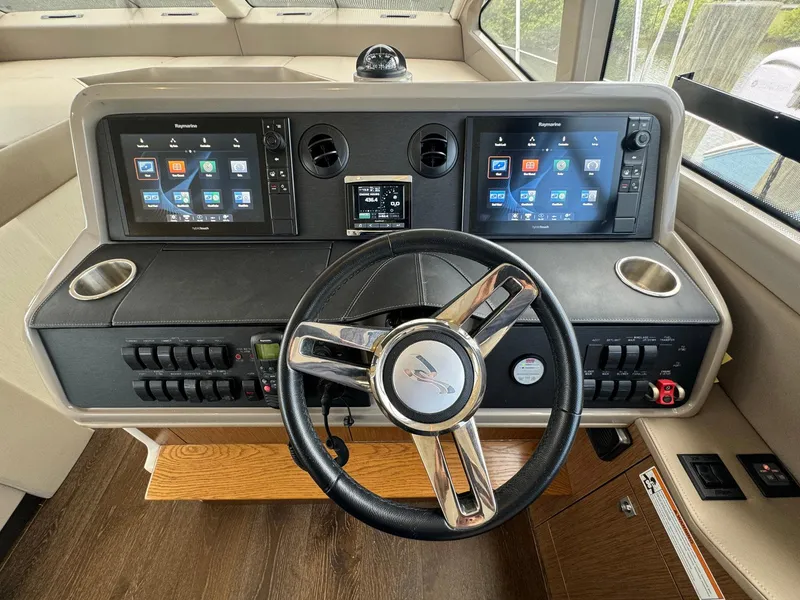 Slide: The Image of 2017 Sea Ray Sundancer 460 helm with dual navigation screens and modern controls. - 7