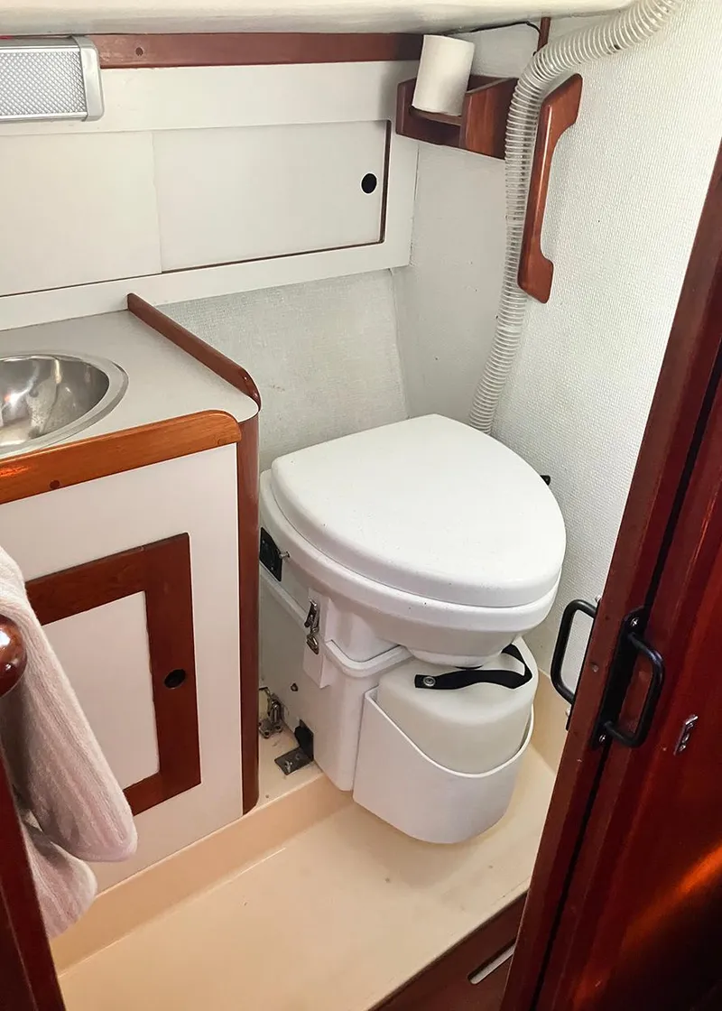 Slide: The Image of 1983 Freedom Cat Ketch boat bathroom with compact toilet and sink. - 14