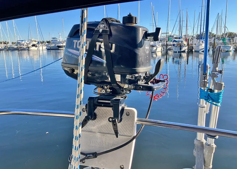 Slide: The Image of 1983 Freedom Cat Ketch with Tohatsu outboard motor in marina setting. - 15