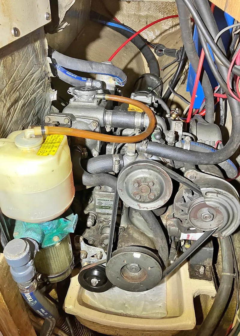 Slide: The Image of 1983 Freedom Cat Ketch engine compartment with belts, hoses, and fluid reservoir. - 16