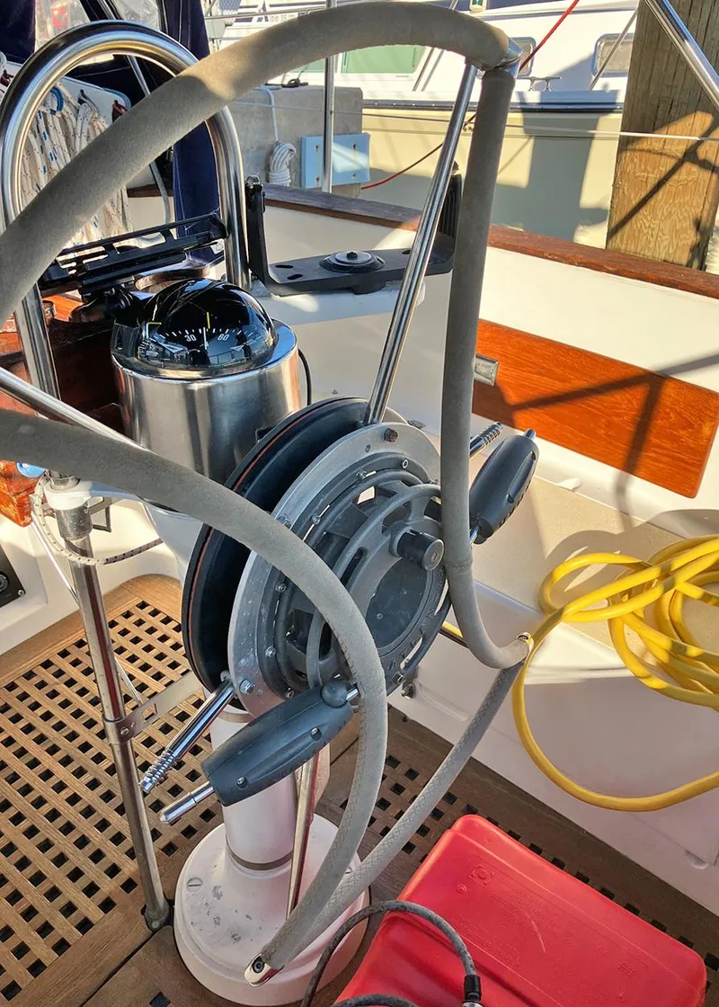 Slide: The Image of 1983 Freedom Cat Ketch sailboat helm with steering wheel and compass. - 6