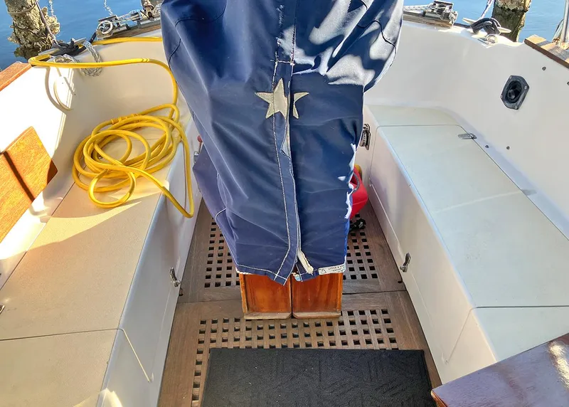 Slide: The Image of 1983 Freedom Cat Ketch sailboat cockpit with blue cover and yellow rope. - 7