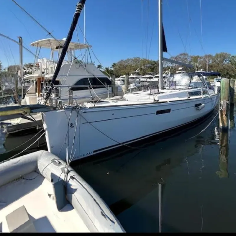 The Image of Interior of 2016 Beneteau Oceanis 45 yacht, featuring dining area and kitchen. - 0