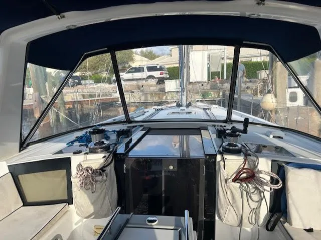 Slide: The Image of Beneteau Oceanis 45 cockpit, 2016 model, featuring navigation equipment and protective canopy. - 10