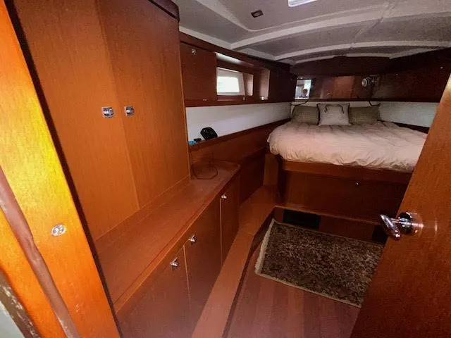 Slide: The Image of Cozy bedroom in 2016 Beneteau Oceanis 45 yacht with plush bedding and decorative pillows. - 14