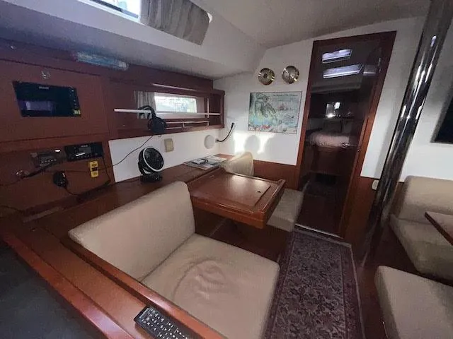Slide: The Image of Interior of 2016 Beneteau Oceanis 45 yacht with wood finish and cozy seating area. - 18