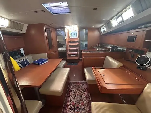 Slide: The Image of Interior of 2016 Beneteau Oceanis 45 yacht, featuring wooden cabinetry and cozy sleeping area. - 19