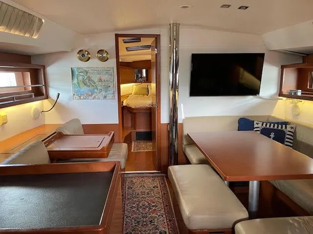 Slide: The Image of Interior of 2016 Beneteau Oceanis 45 yacht, featuring cozy seating and modern amenities. - 23