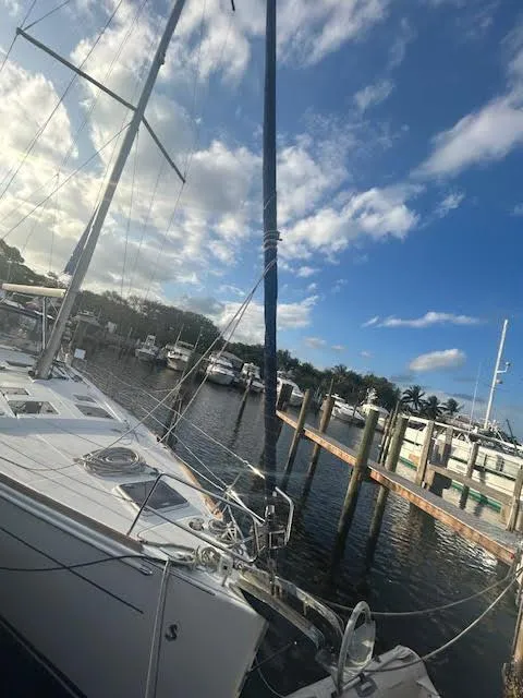 Slide: The Image of 2016 Beneteau Oceanis 45 sailboat mast against a blue sky at a marina. - 33