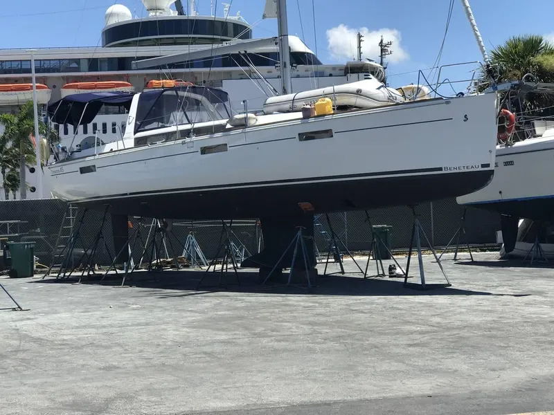 Slide: The Image of 2016 Beneteau Oceanis 45 sailboat docked at marina, residential background. - 42