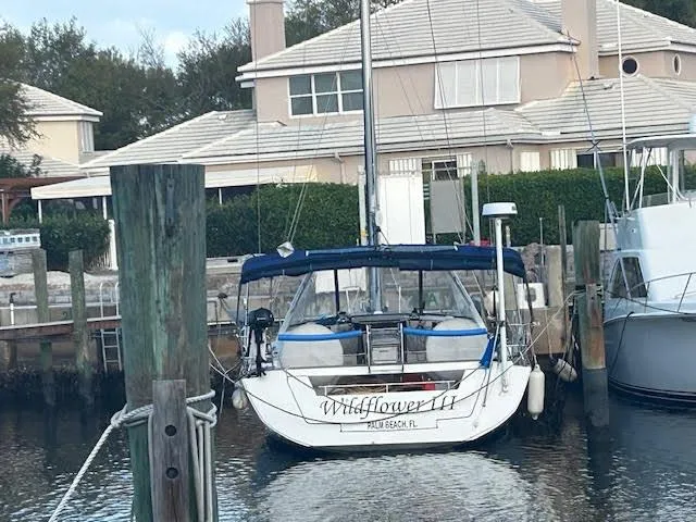 Slide: The Image of Beneteau Oceanis 45 sailboat docked, 2016 model, named "Wildflower II" in a marina setting. - 5