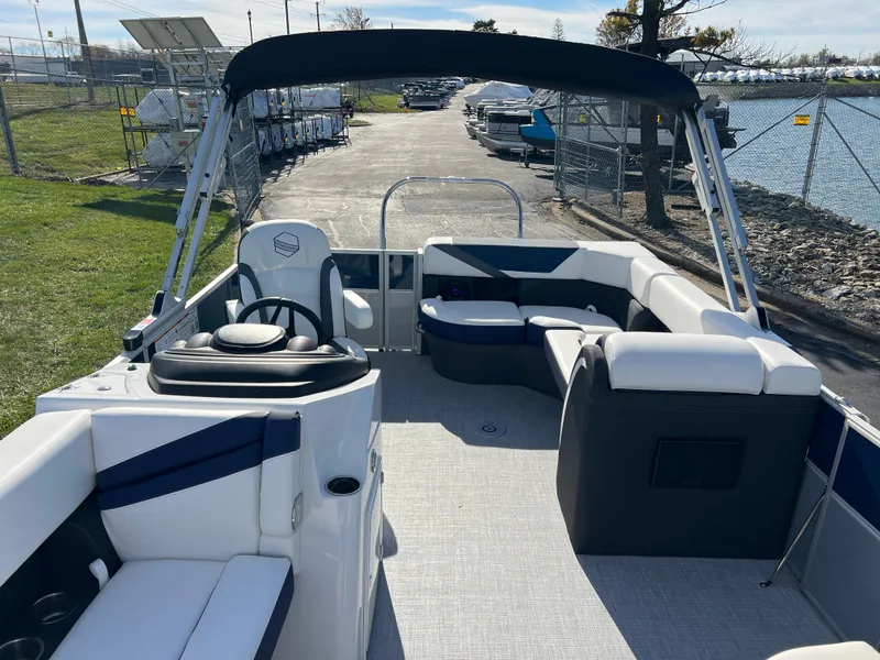 Slide: The Image of 2025 South Bay S 220CR2 pontoon boat interior with seating and steering wheel. - 11