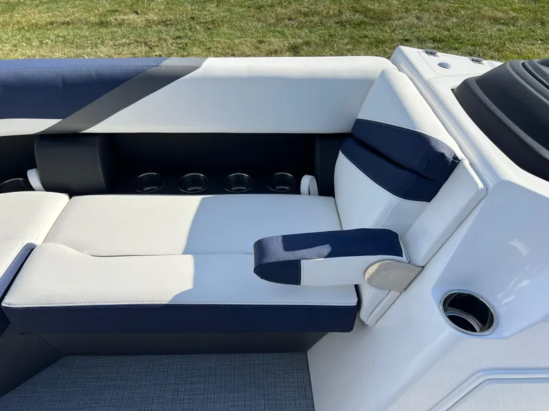 Slide: The Image of 2025 South Bay S 220CR2 boat interior with white and navy seating. - 12