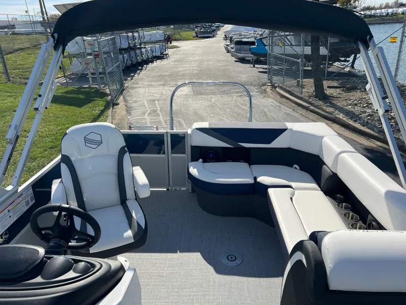 Slide: The Image of 2025 South Bay S 220CR2 pontoon boat interior with seating and steering wheel. - 15