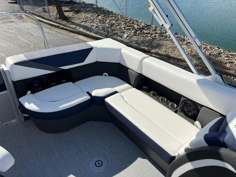 Slide: The Image of 2025 South Bay S 220CR2 boat interior with plush seating and cup holders. - 16