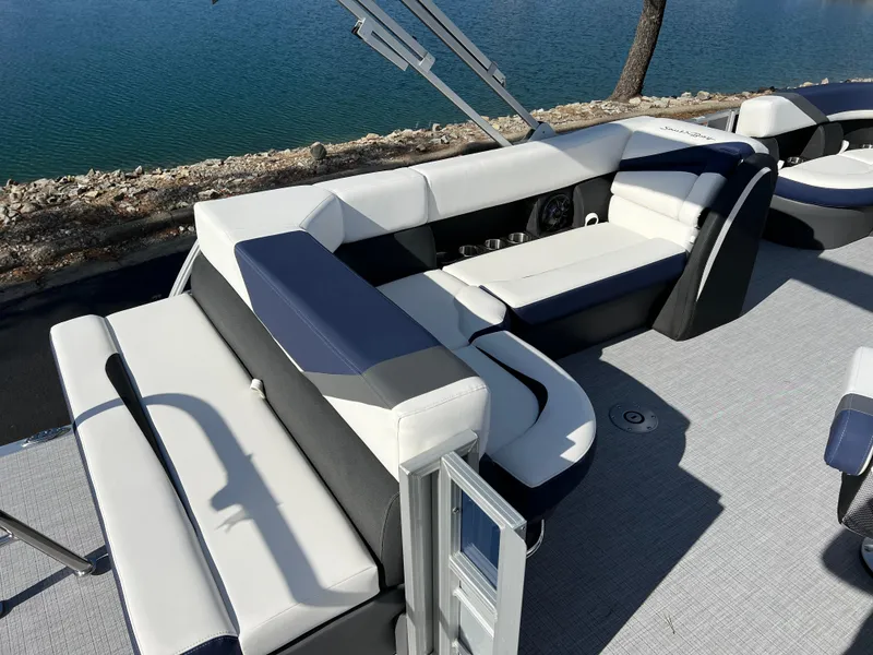 Slide: The Image of 2025 South Bay S 220CR2 pontoon boat with stylish seating by the water. - 18
