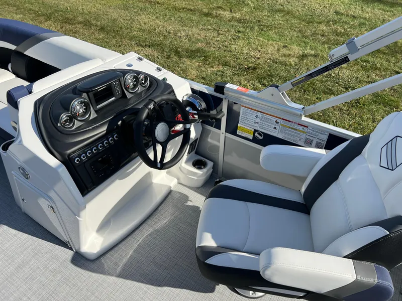 Slide: The Image of 2025 South Bay S 220CR2 boat interior with modern dashboard and comfortable seating. - 21