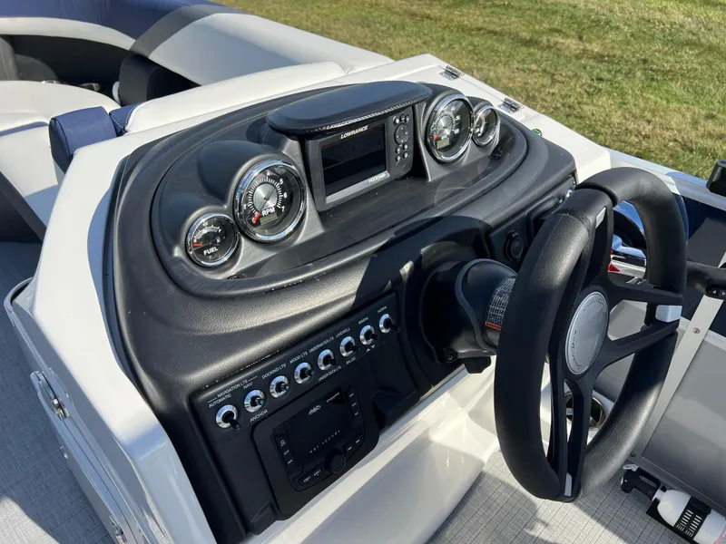 Slide: The Image of 2025 South Bay S 220CR2 boat dashboard with steering wheel and control panel. - 22