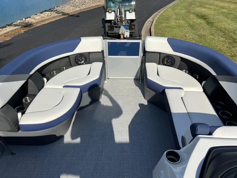 Slide: The Image of 2025 South Bay S 220CR2 pontoon boat interior with plush seating and cup holders. - 26