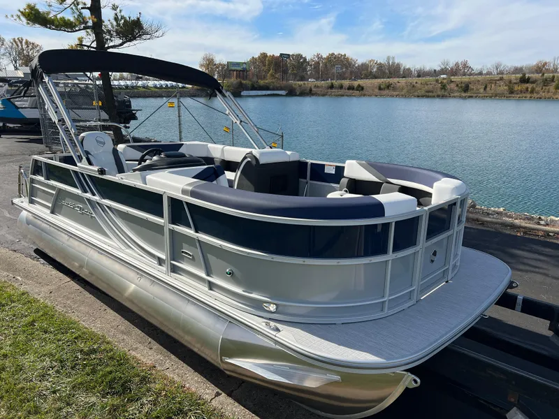 Slide: The Image of 2025 South Bay S 220CR2 pontoon boat docked by a serene lake. - 3