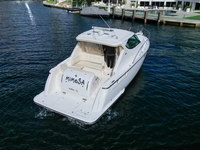 Slide: The Image of 2008 Tiara Yachts 3900 Sovran cruising on water near docks. - 14