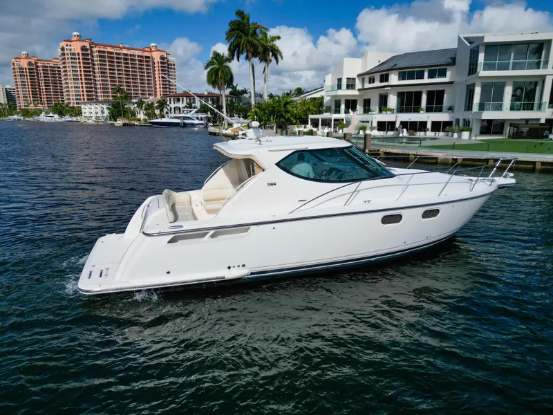 Slide: The Image of 2008 Tiara Yachts 3900 Sovran cruising near luxury waterfront homes. - 15