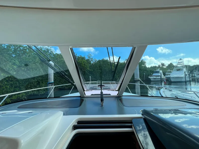 Slide: The Image of 2008 Tiara Yachts 3900 Sovran cockpit view with marina backdrop. - 34