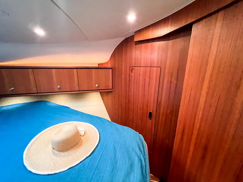 Slide: The Image of 2008 Tiara Yachts 3900 Sovran cabin with wooden interior and blue bedding. - 48
