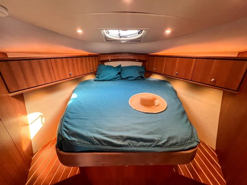 Slide: The Image of Luxurious cabin interior of 2008 Tiara Yachts 3900 Sovran with cozy bed and wooden accents. - 49