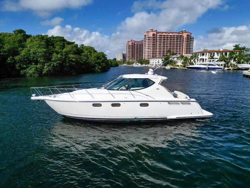 Slide: The Image of 2008 Tiara Yachts 3900 Sovran cruising on a scenic waterway with lush greenery. - 5