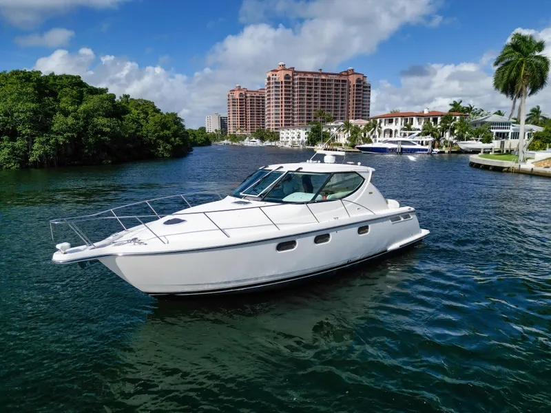 Slide: The Image of 2008 Tiara Yachts 3900 Sovran cruising on a scenic waterway with lush greenery. - 7