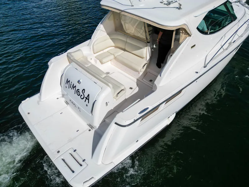Slide: The Image of 2008 Tiara Yachts 3900 Sovran cruising on water, rear view. - 8