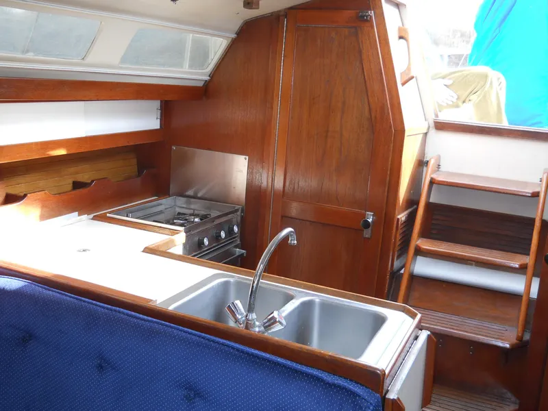 Slide: The Image of Interior of 1987 Catalina C-34 sailboat with kitchen and wooden cabinetry. - 14