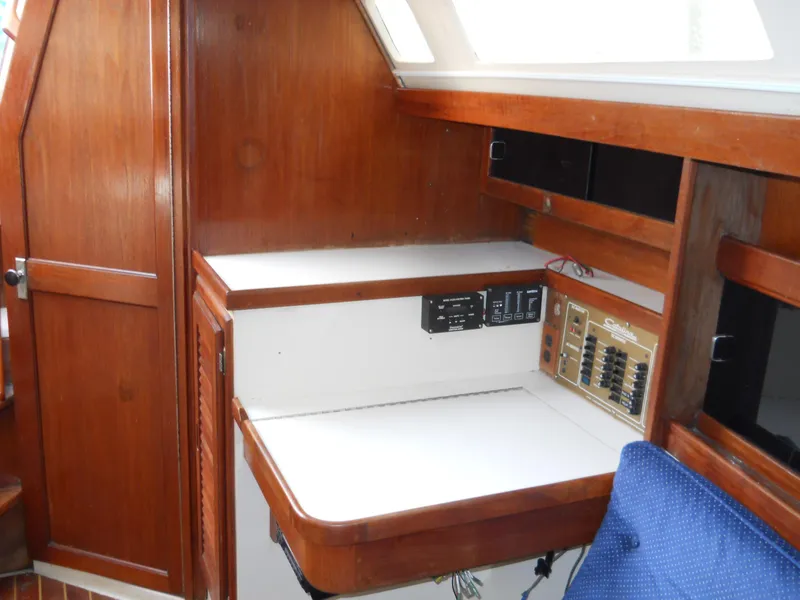 Slide: The Image of Interior of 1987 Catalina C-34 sailboat with wooden cabinetry and navigation station. - 15