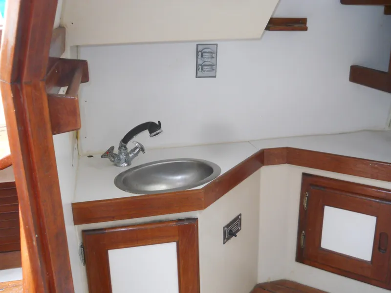 Slide: The Image of 1987 Catalina C-34 yacht interior with sink and wooden cabinetry. - 17