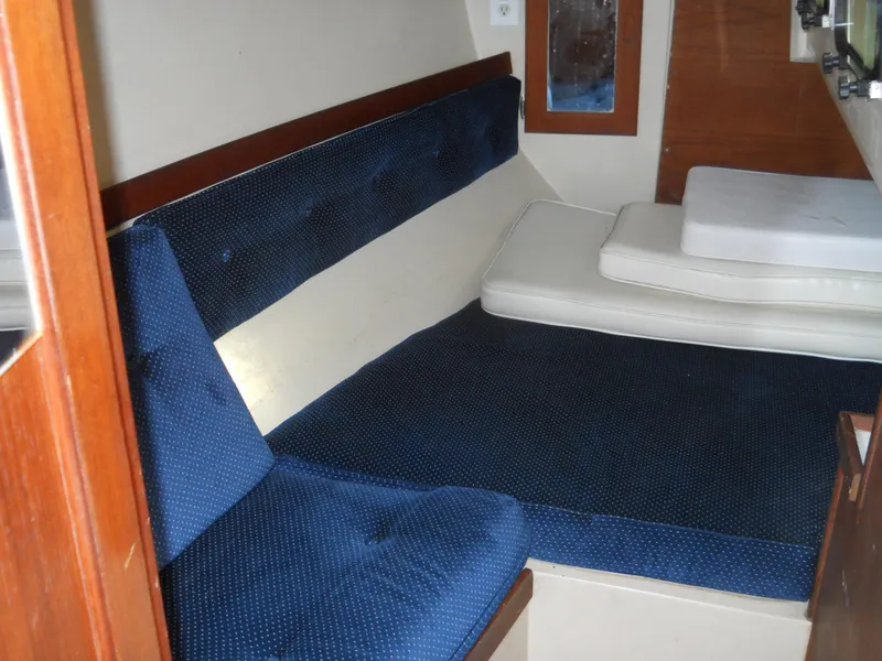 Slide: The Image of Interior cabin of 1987 Catalina C-34 sailboat with blue upholstery and cushions. - 18