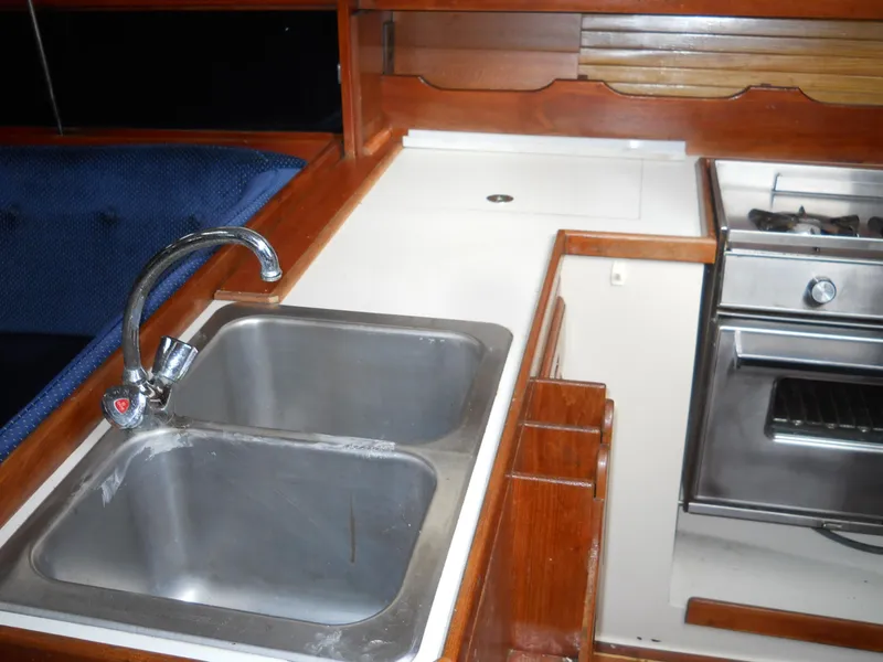 Slide: The Image of 1987 Catalina C-34 yacht kitchen with dual sink and stove. - 9