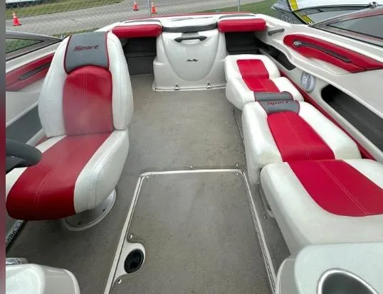 Slide: The Image of 2006 Sea Ray 205 Sport boat interior with red and white seating, spacious layout. - 5