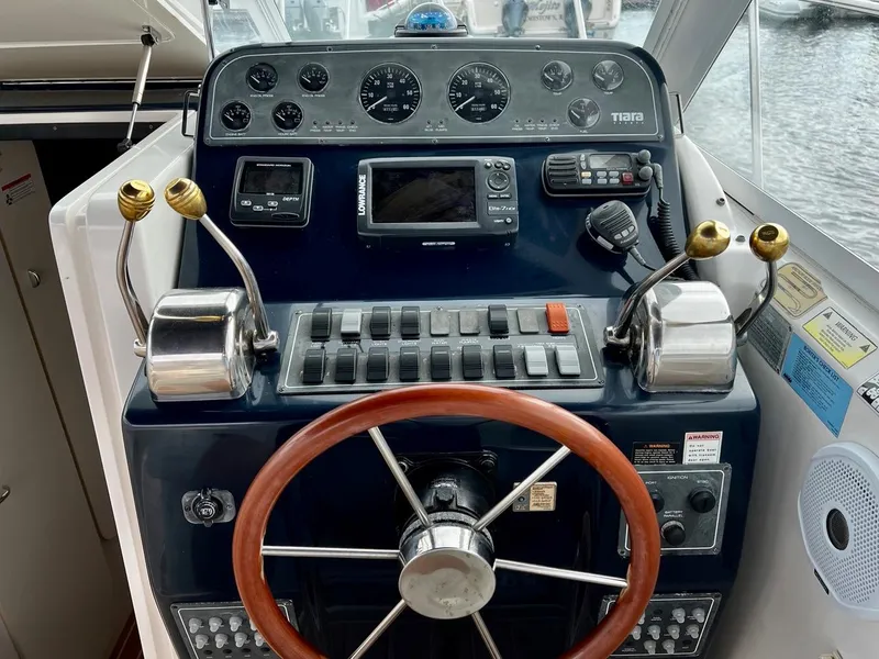 Slide: The Image of 2001 Tiara Yachts 2900 Coronet helm with steering wheel and control panel. - 10