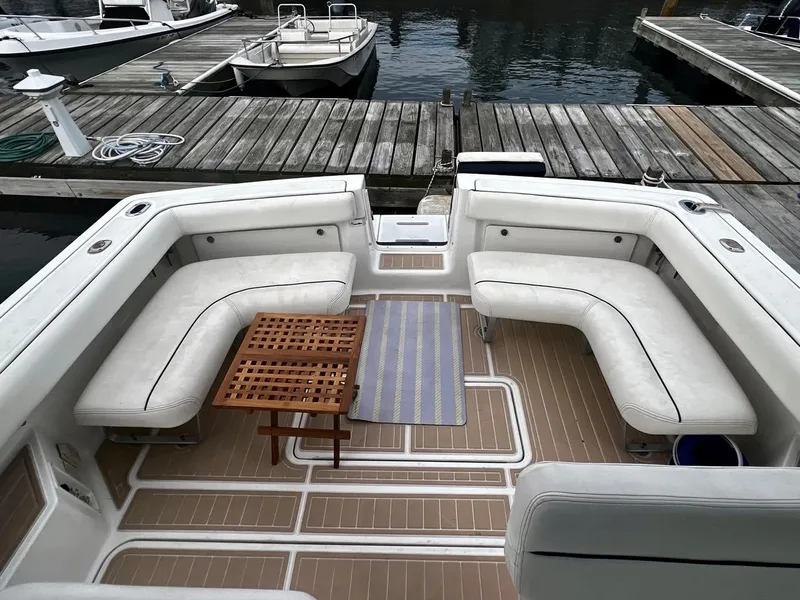 Slide: The Image of 2001 Tiara Yachts 2900 Coronet with spacious seating and wooden table at dock. - 13